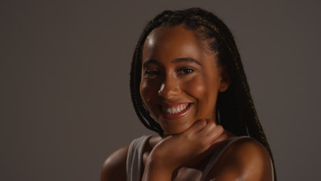 Studio-Beauty-Shot-Of-Smiling-Young-Woman-With-Long-Braided-Hair-With-Shadow-Lighting-1